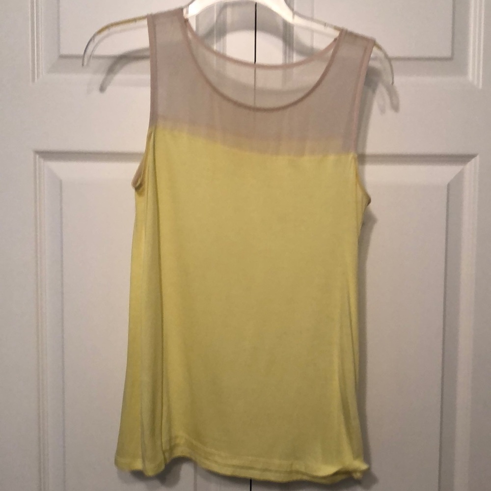 Yellow sleeveless top.